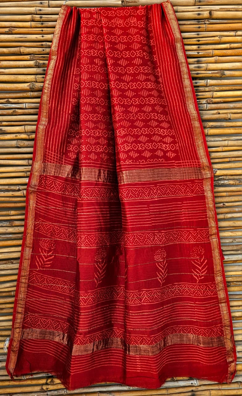 red hand-block printed Maheshwari silk/cotton blend saree with traditional and floral motifs and a golden zari border