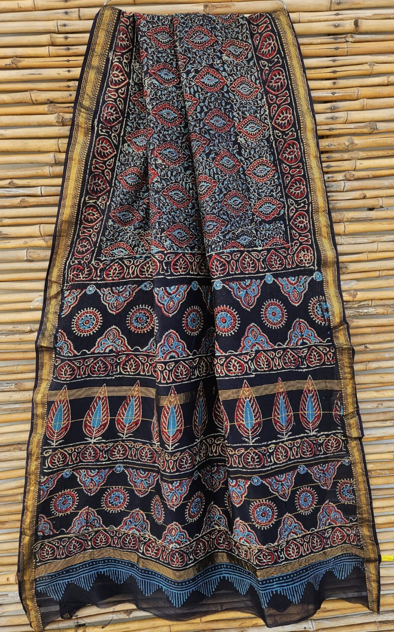 black hand-block printed Ajrakh or Maheshwari silk/cotton blend saree with traditional red and blue motifs and a golden zari border