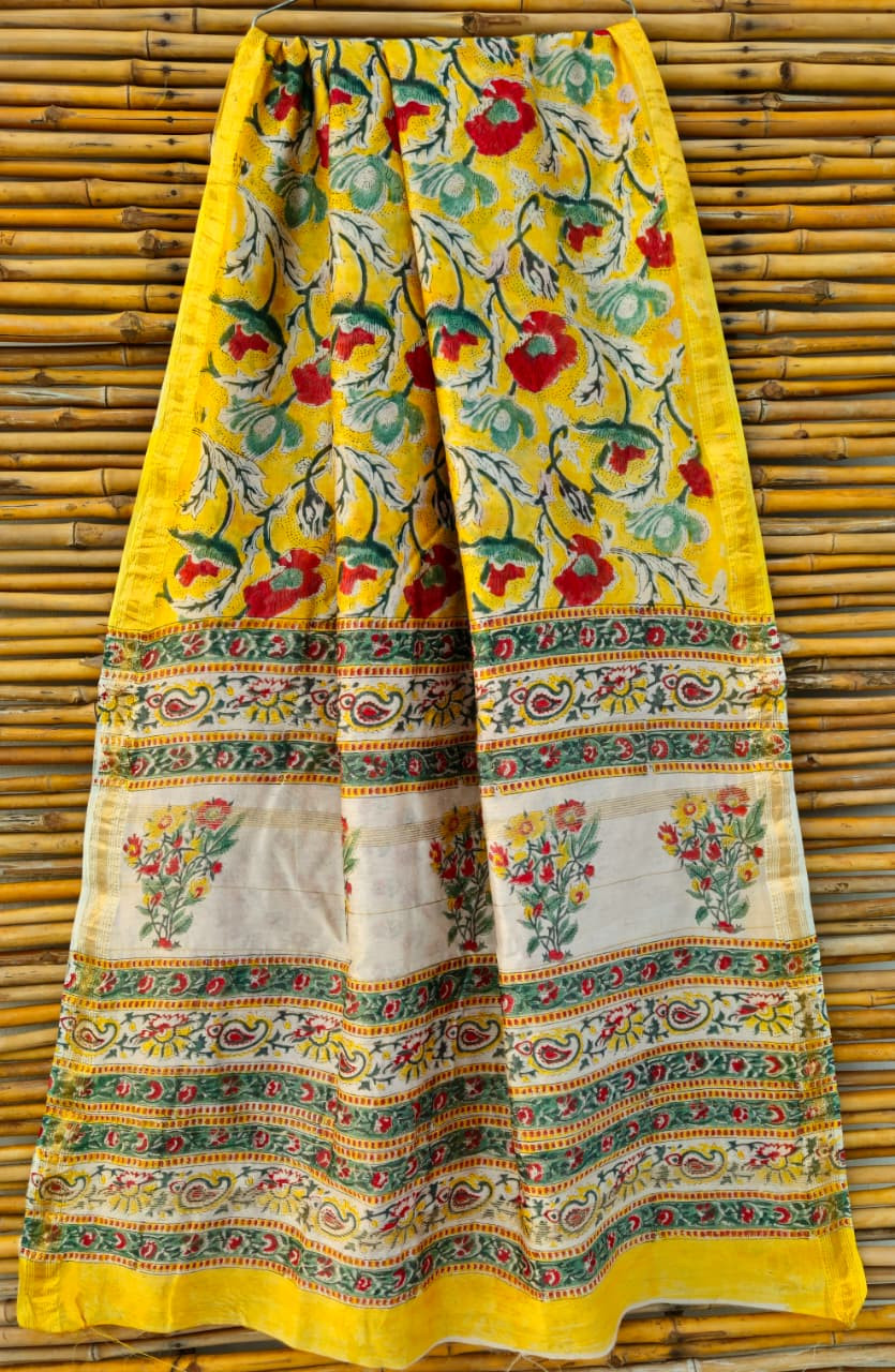 hand-block printed Maheshwari or Chanderi silk-cotton blend saree in a yellow, red, and green floral design with a golden zari border.