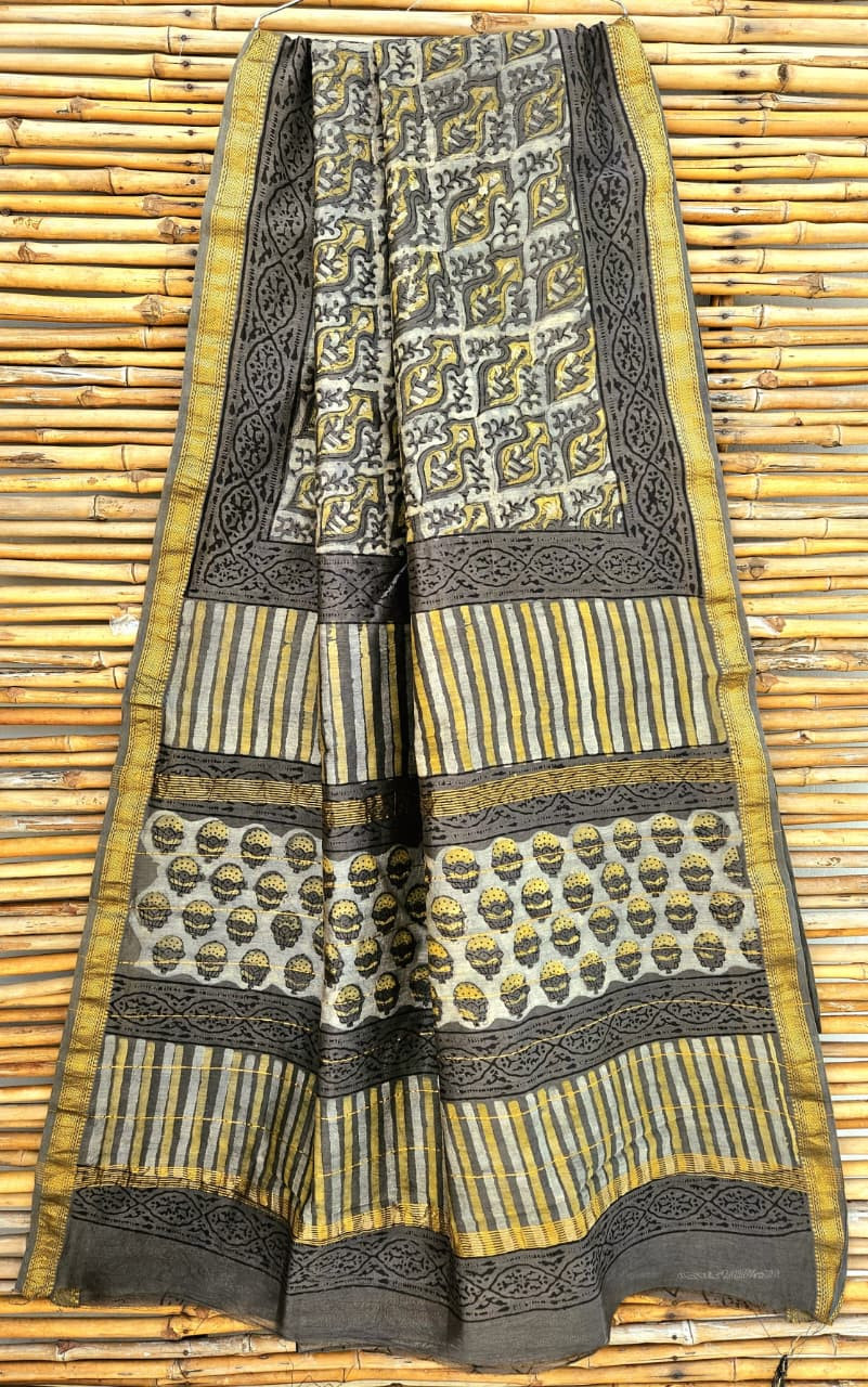 grey and yellow Maheshwari silk-cotton handloom saree featuring hand-block printed floral and geometric patterns and a gold zari border design.