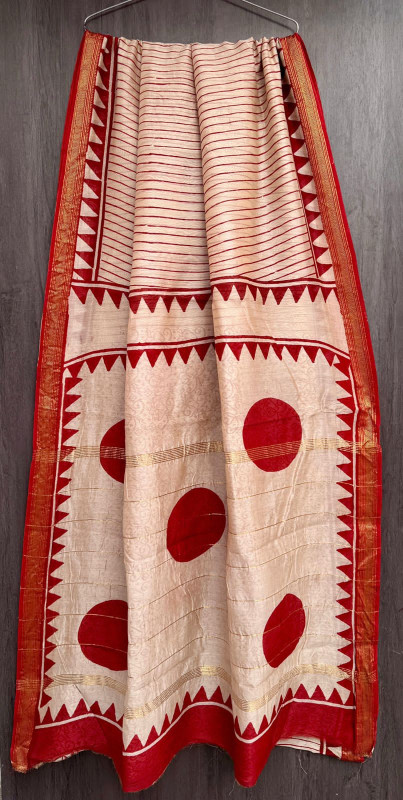 red and white hand-block printed Maheshwari or Chanderi silk/cotton blend saree with traditional motifs, large circular designs, and a golden zari border.