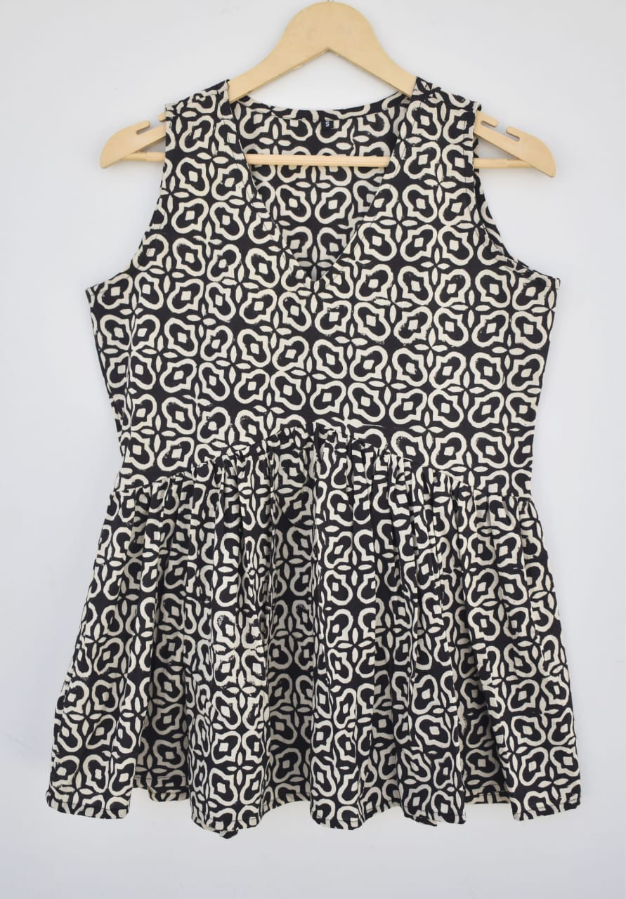 Black and off-white (or cream), hand-block printed, geometric or quatrefoil pattern, cotton sleeveless peplum top.