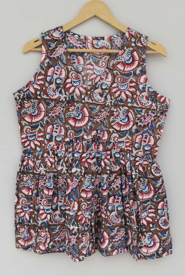 brown, red, and blue hand-block printed, floral or paisley pattern cotton sleeveless peplum top.