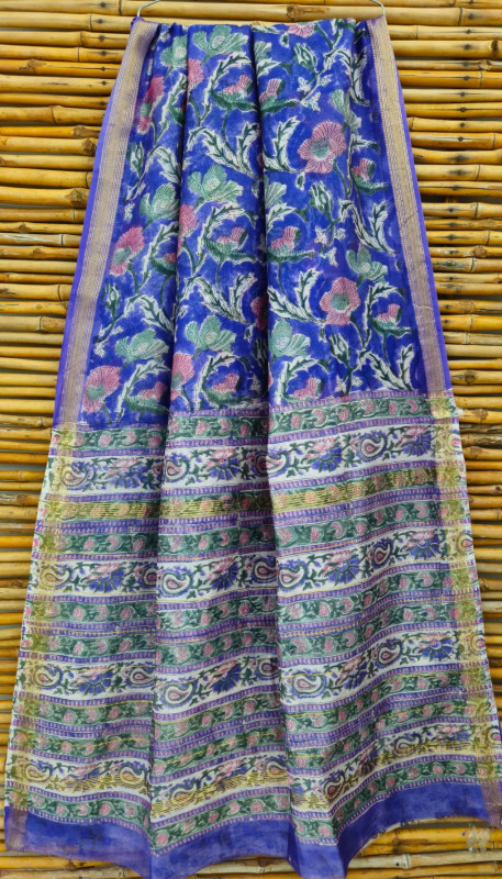 blue hand-block printed Maheshwari silk/cotton blend saree with pink and green traditional floral and paisley motifs and a golden zari border.