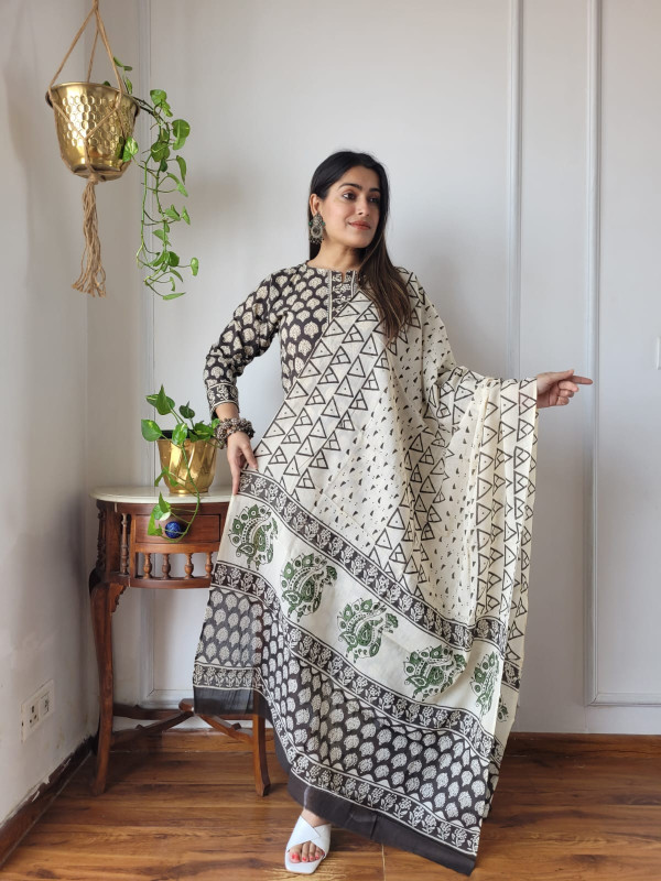 light yellow (or beige) and multicolour floral and bird hand block printed cotton kurta, pants, and dupatta suit set.