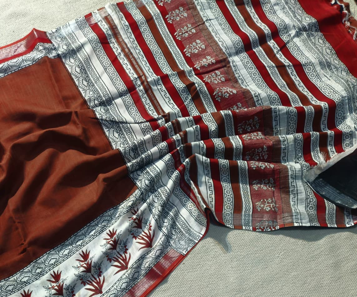 terracotta and multi-colored Bagru hand block printed cotton fabric with a striped and floral design.